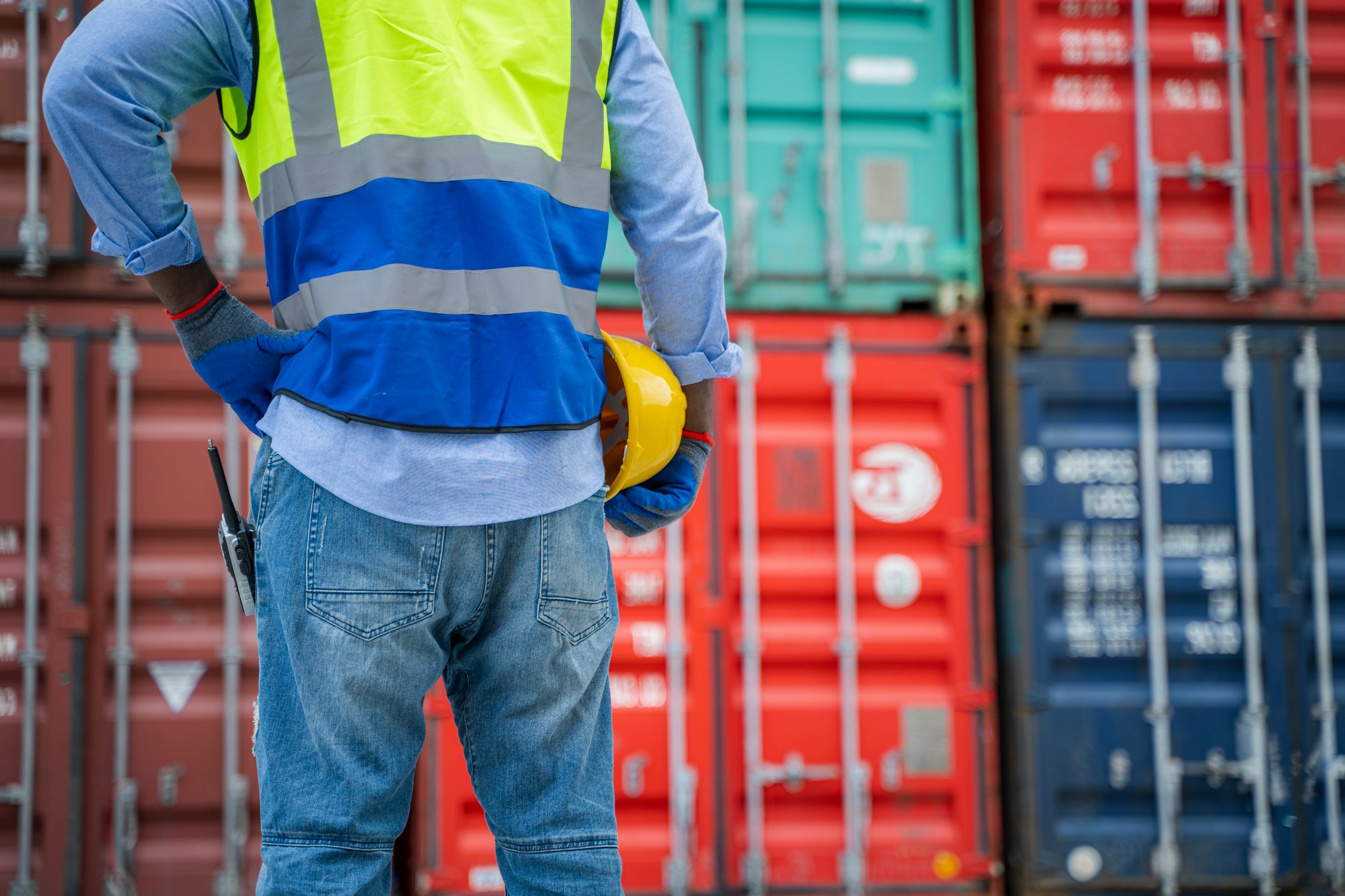 Worker check list of container cargo at container depot terminal.